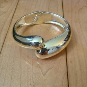 Gold tone spring loaded bracelet
